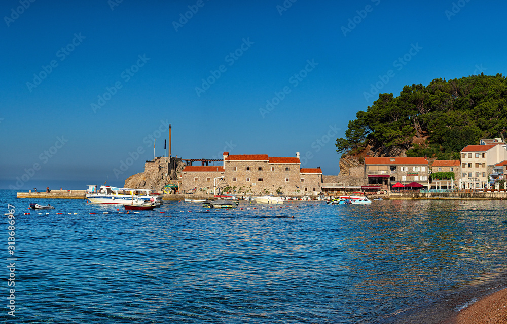 View on Petrovac and its beach in summer full of tourists