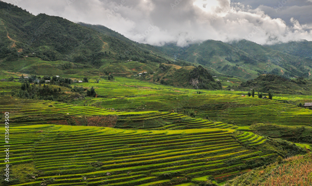 Vietnamese mountain landscape with rice fields and small villages in the mountains of Sapa area in Vietnam Asia.