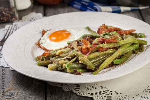 Healthy sauteed green beans with bacon and fried egg