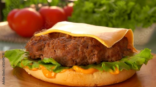 Cesam bun falls on the table. Prepared products for hamburgers on the table  photo