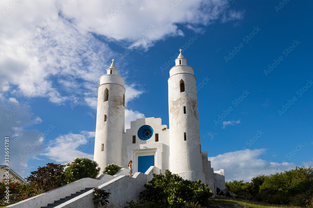 Female tourist in front of a Church in Deadman's Cay, Long island Bahamas