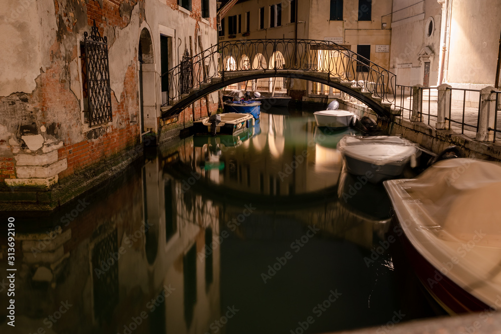 docked boats on a picturesque water canal in Venice italy