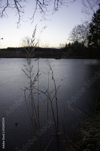 Sunset on pond in winter