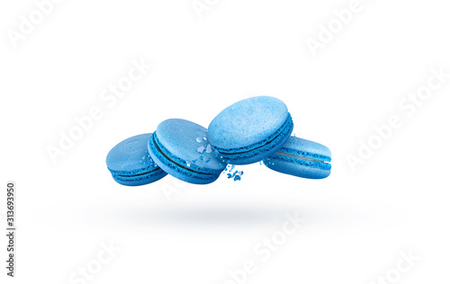 Blue macaroon cookies in motion falling on a white background. 