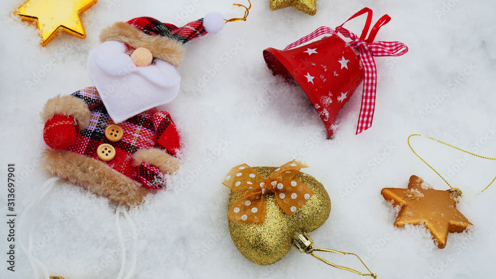 Christmas toys lie on the snow, festive background. The pattern of the toys.