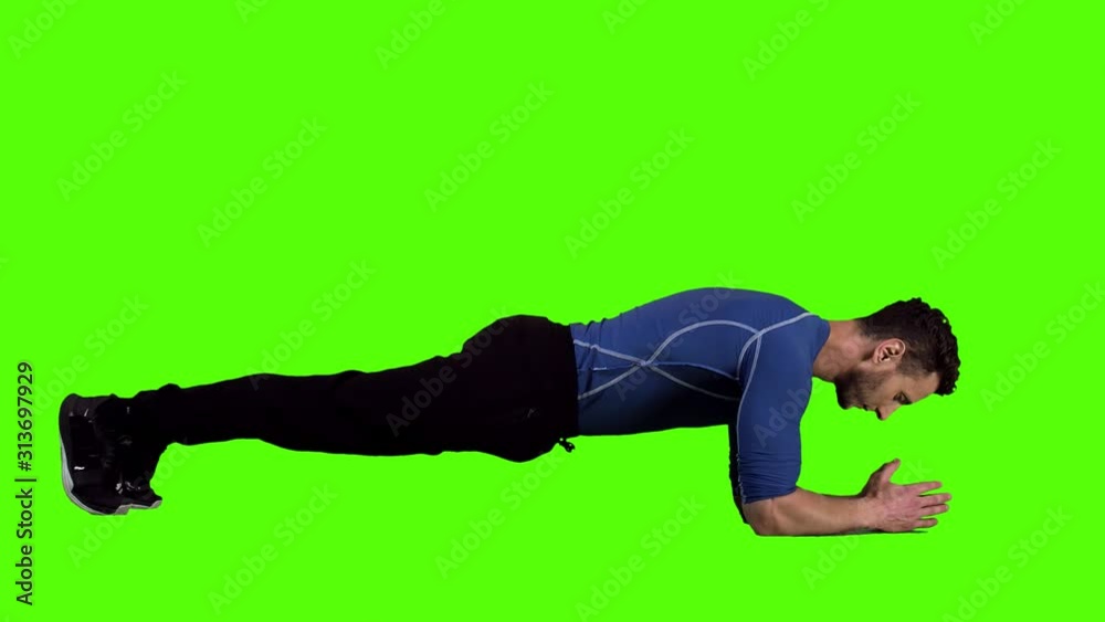 Muscular Man Doing Push Up-Crunches Over Green Screen, Long Shot. Muscular Man Doing Push Up-Crunches Over Green Screen, Long Shot.
