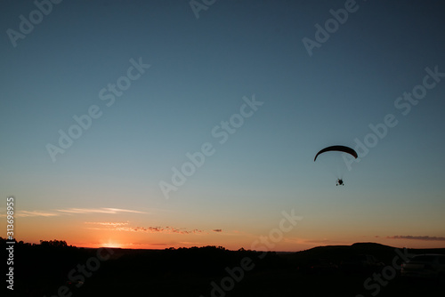 paragliding at sunset