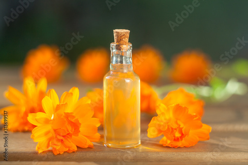 Essence of lavender flowers on table in beautiful glass bottle