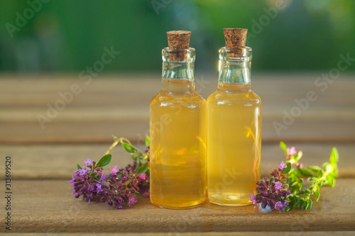 thyme essential oil in beautiful bottle on table