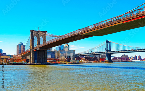 Manhattan and Brooklyn bridge across East River, New York, USA. It is among the oldest in the United States of America. NYC, US. Skyline and cityscape. American construction