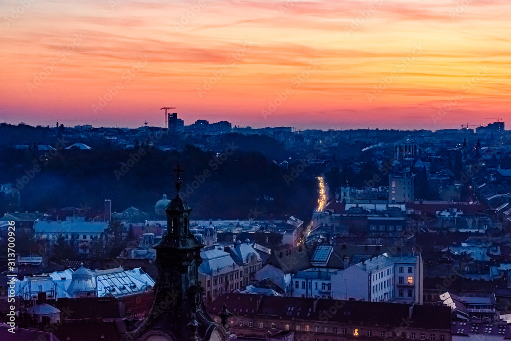 Fototapeta premium View on a historic center of Lviv at sunset. View on Lvov cityscape from the town hall
