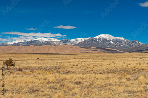 Vászonkép Looking across the Plains at Sand Dunes and Snowy Mountains