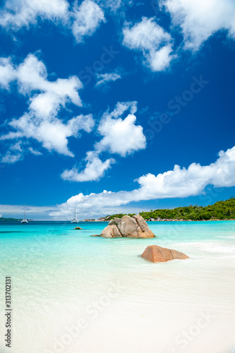 Bright scenic view of granite boulder landscape of Anse Lazio beach on Praslin Island in the Seychelles