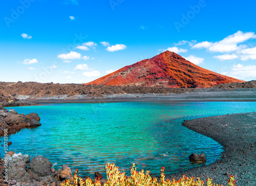 Unique volcanic lanscape of Lanzarote island with black sands and red mountains. Canary islands of Spain