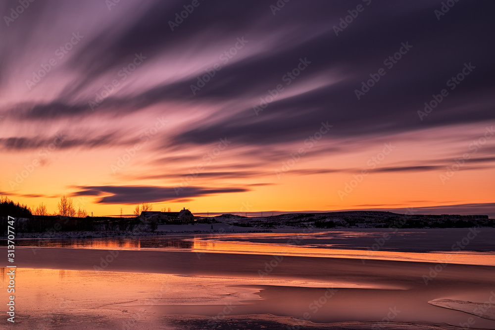 Sunset in Heidmork lake with a long exposure and clouds in moviment, Iceland Sunset in Heidmork lake with a long exposure and clouds in moviment, Iceland