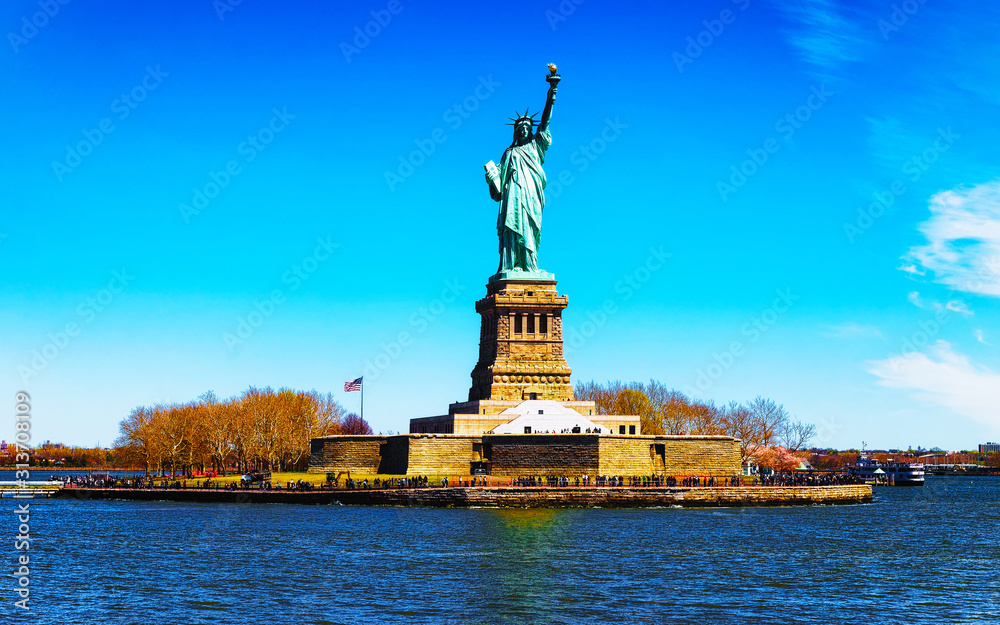 Fototapeta premium Statue on Liberty Island, USA, in Upper New York Bay on Manhattan City Area, America. American architecture building. Metropolis NYC. Cityscape. Hudson, East River NY. Symbol of Freedom.