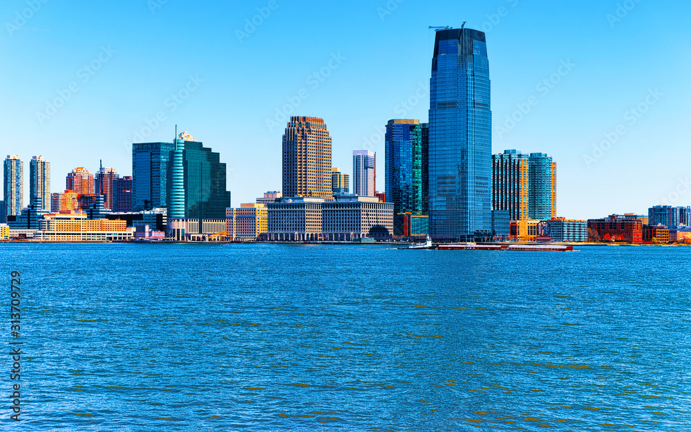 Fototapeta premium Jersey City, New Jersey and Hudson River. View from Manhattan, New York of USA. Skyline and cityscape with skyscrapers at United States of America, NYC, US. Road and American architecture.