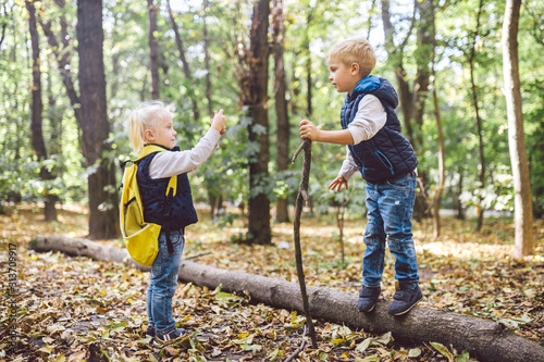 Children preschoolers Caucasian brother and sister take pictures of each other on mobile phone camera in forest park autumn. theme of hobby and active lifestyle for child. Profession photographer © Elizaveta