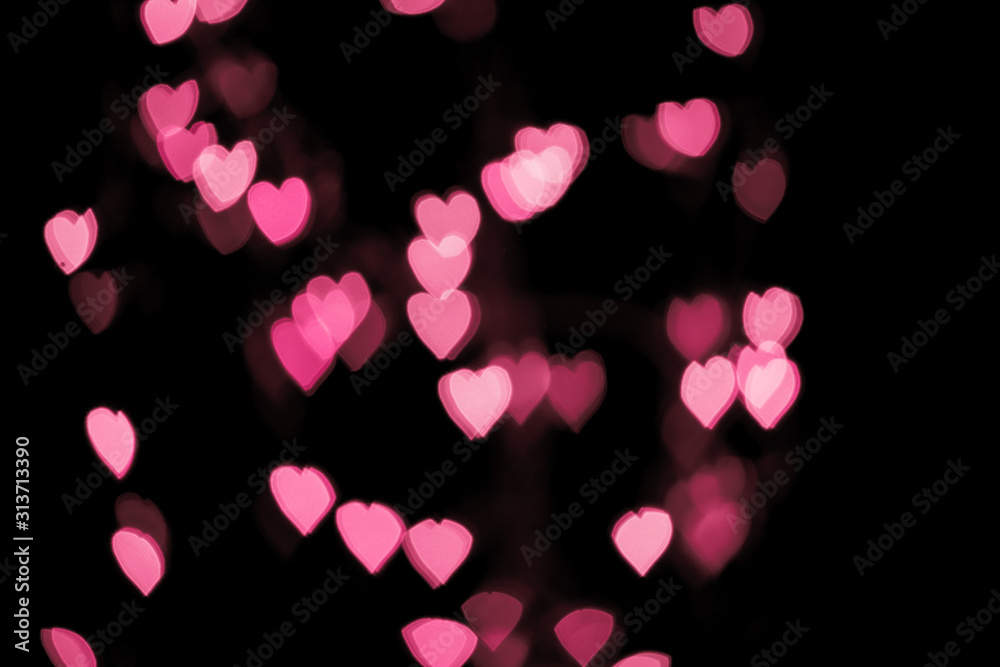 Valentines background. Abstract pink bokeh background. Defocused blurred heart shaped lights. St. Valentines Day background Valentines background. Abstract pink bokeh background. Defocused blurred heart shaped lights. St. Valentines Day background