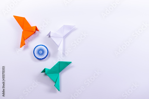 Valokuva Top view of orange bird,  green bird, white bird and symbol Flag of India on white background