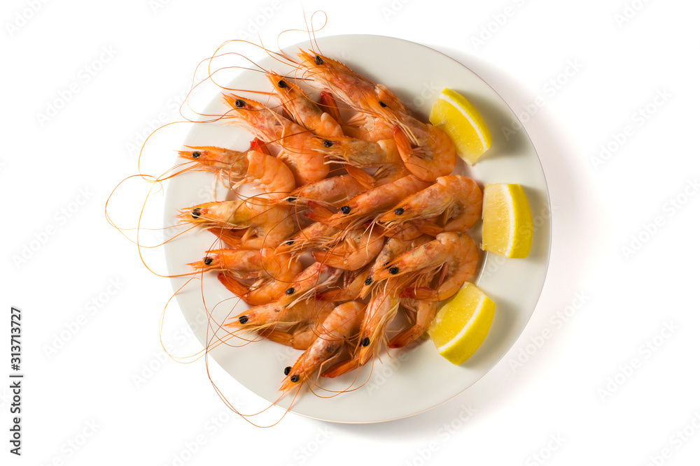 White plate with tasty shrimps with lemon isolated on white background. Top view White plate with tasty shrimps with lemon isolated on white background. Top view