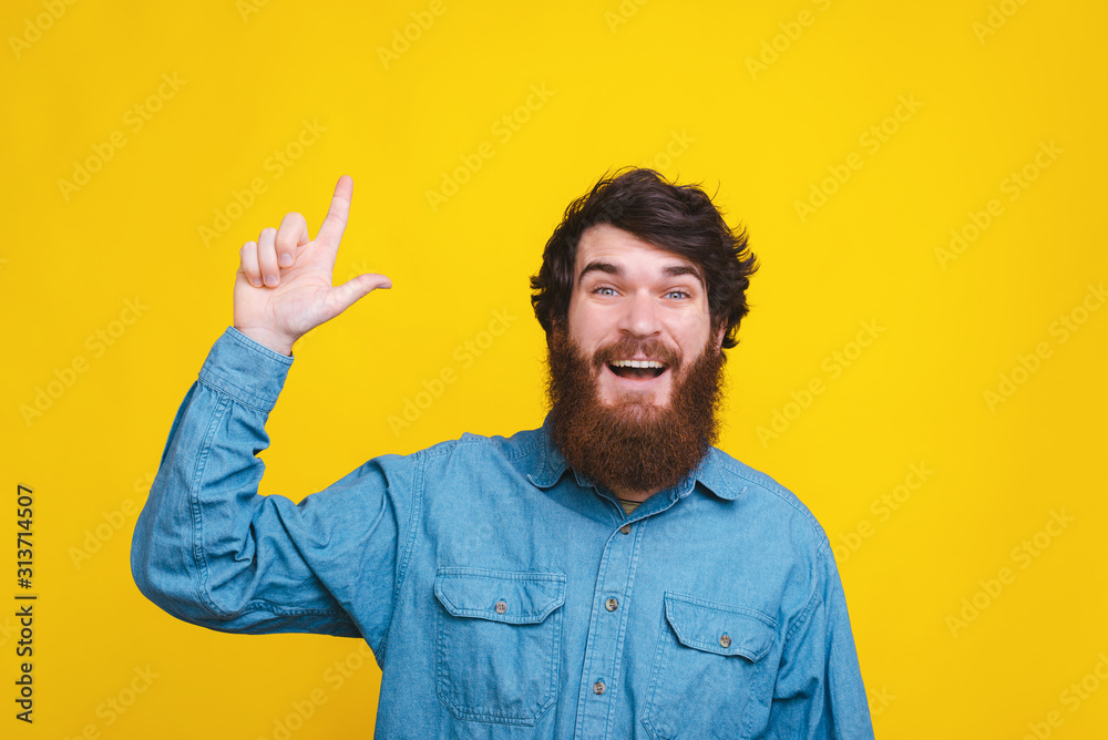 Amazed funny man pointing up at copyspace Amazed funny man pointing up at copyspace