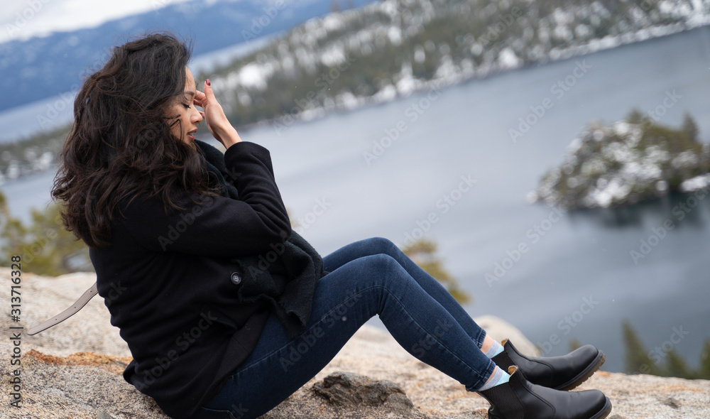 Female Asian model overlooking lake and mountain view