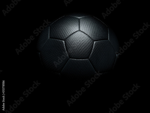 Naklejka Black soccer ball against black background.
