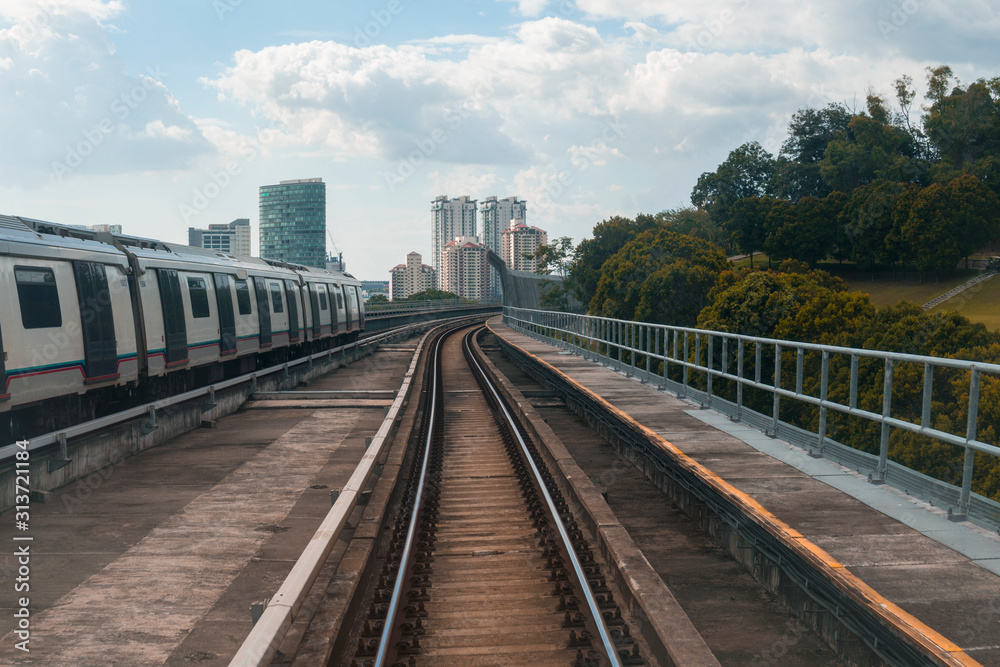 Public train track with view of skyscrapers. Transportation concept.