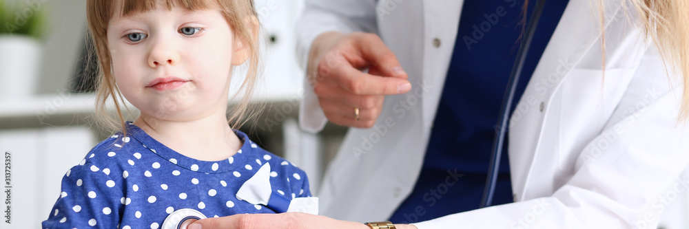 Little child with stethoscope at doctor reception Little child with stethoscope at doctor reception