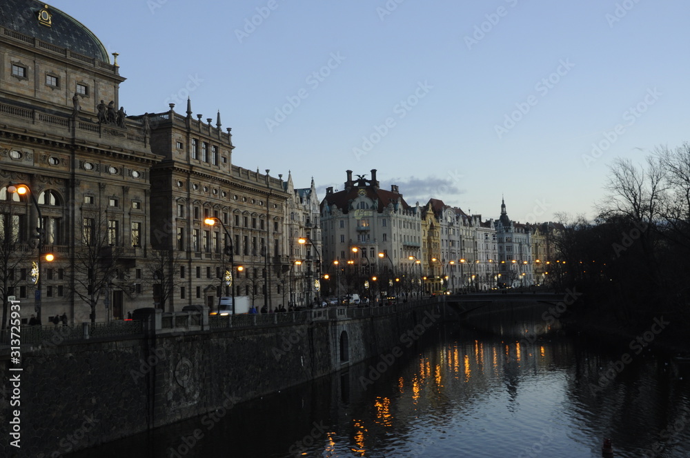View of water and city in Prague Czech Republic at sunset