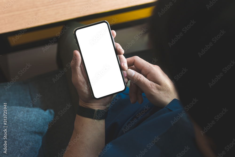 Mockup image blank white screen cell phone.man hand holding texting using mobile on desk at office.background empty space for advertise text.people contact marketing business,technology Mockup image blank white screen cell phone.man hand holding texting using mobile on desk at office.background empty space for advertise text.people contact marketing business,technology