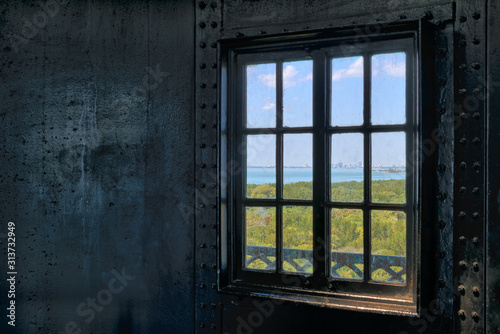 Looking through a lighthouse window at the ocean