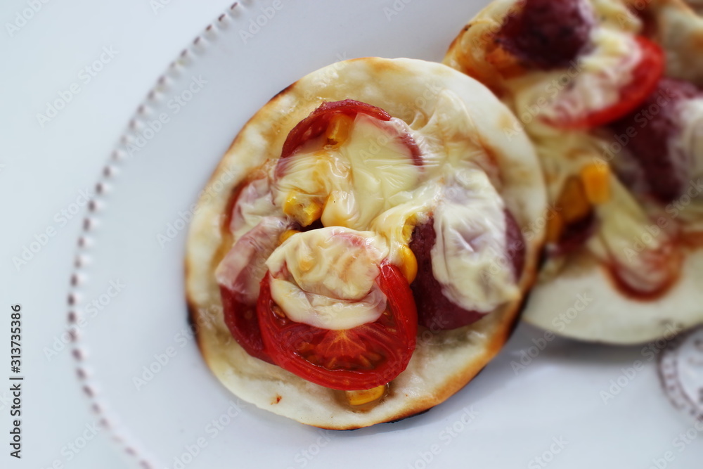 Fusion food, gyoza dough and tomato cheese bake for pizza style Fusion food, gyoza dough and tomato cheese bake for pizza style