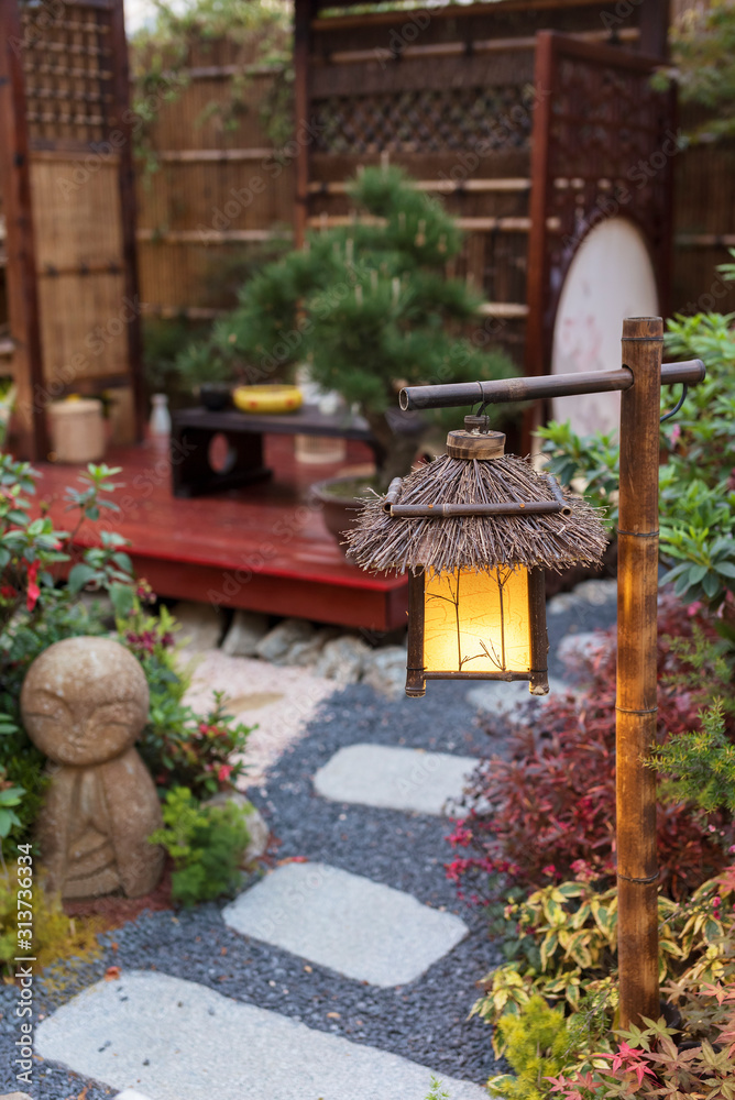 Lantern in beautiful oriental Japanese backyard garden