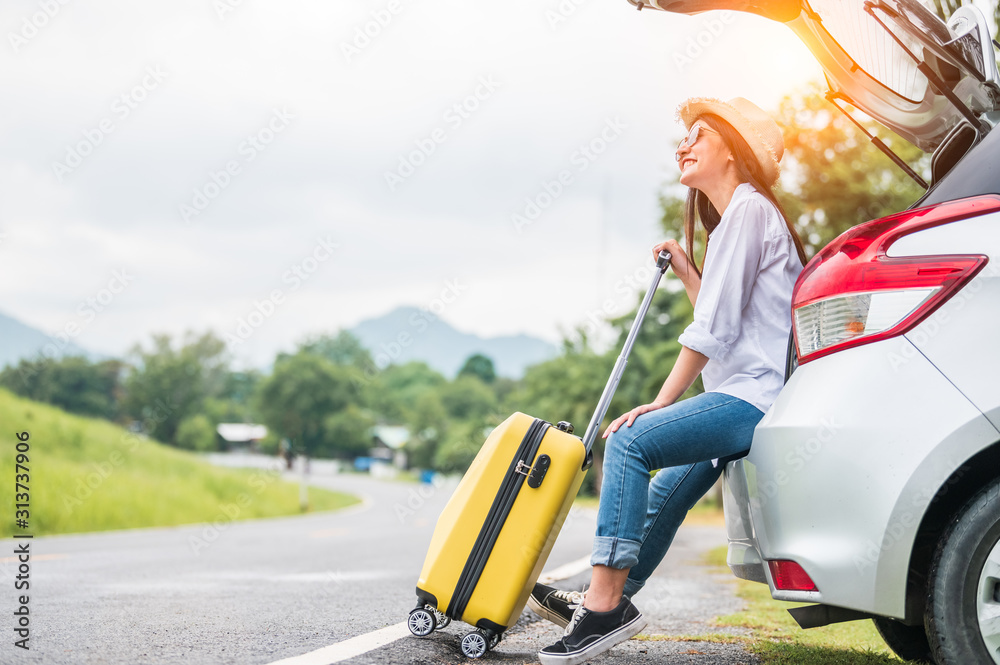 © Shutter2U - Asian woman spending weekend in roadtrip with yellow luggage. Girl relaxing on back of car with road background. Road trip and holiday vacation concept. People lifestyles and transportation. © Shutter2U - Asian woman spending weekend in roadtrip with yellow luggage. Girl relaxing on back of car with road background. Road trip and holiday vacation concept. People lifestyles and transportation.