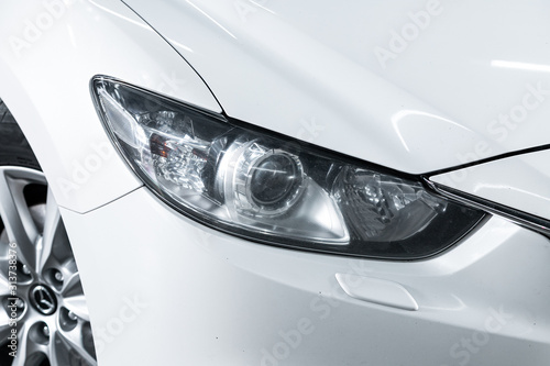 Exterior detail . Close up  of modern  car xenon lamp headlight. photo