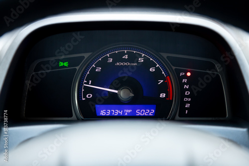 Close up Instrument automobile panel with Odometer, speedometer, tachometer, fuel level.
