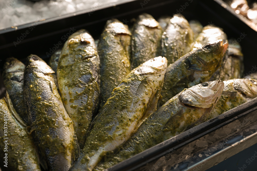 Fresh marinated fish in plastic container, closeup Fresh marinated fish in plastic container, closeup