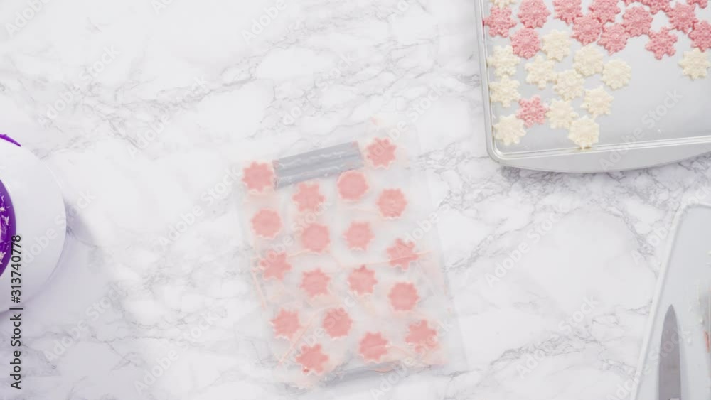 Flat lay. Step by step. Pouring melted chocolate into a plastic chocolate mold in the shape of snowflakes. Flat lay. Step by step. Pouring melted chocolate into a plastic chocolate mold in the shape of snowflakes.