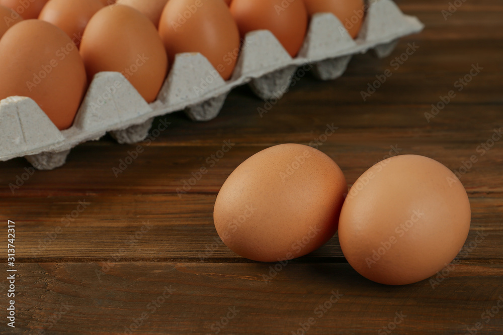 Raw brown chicken eggs on wooden table Raw brown chicken eggs on wooden table