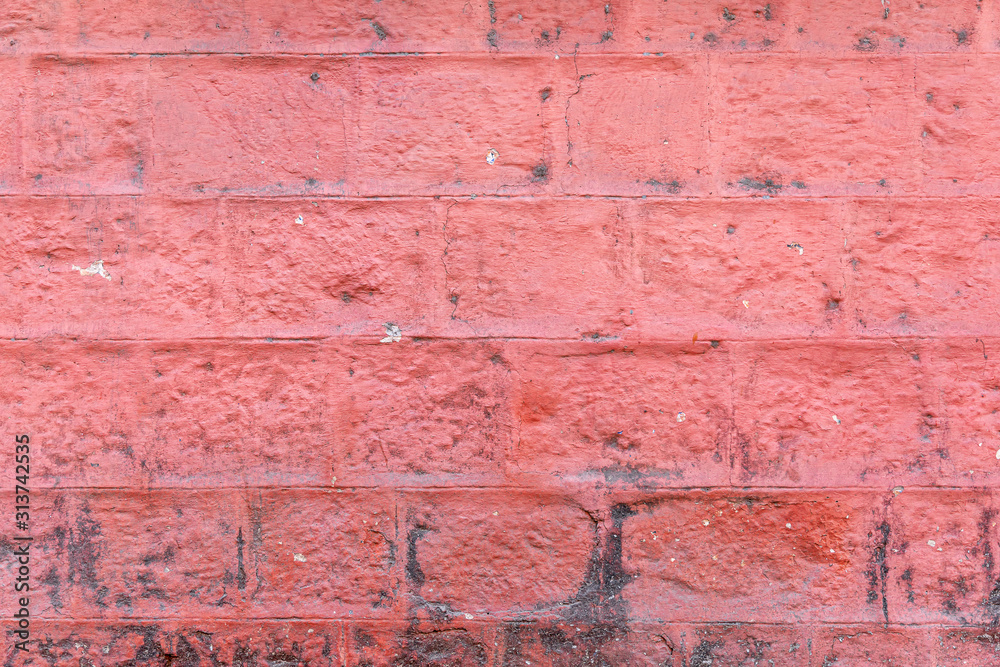 Concrete block wall painted red color of background and texture. Concrete block wall painted red color of background and texture.