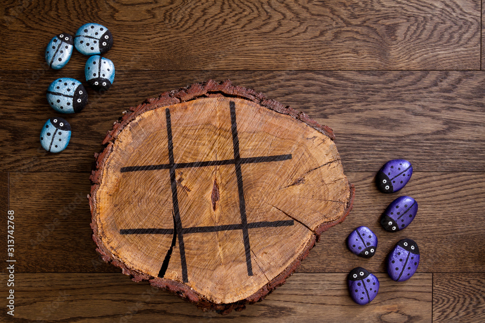Hand made wood burn tic tac toe game with painted rock game pieces