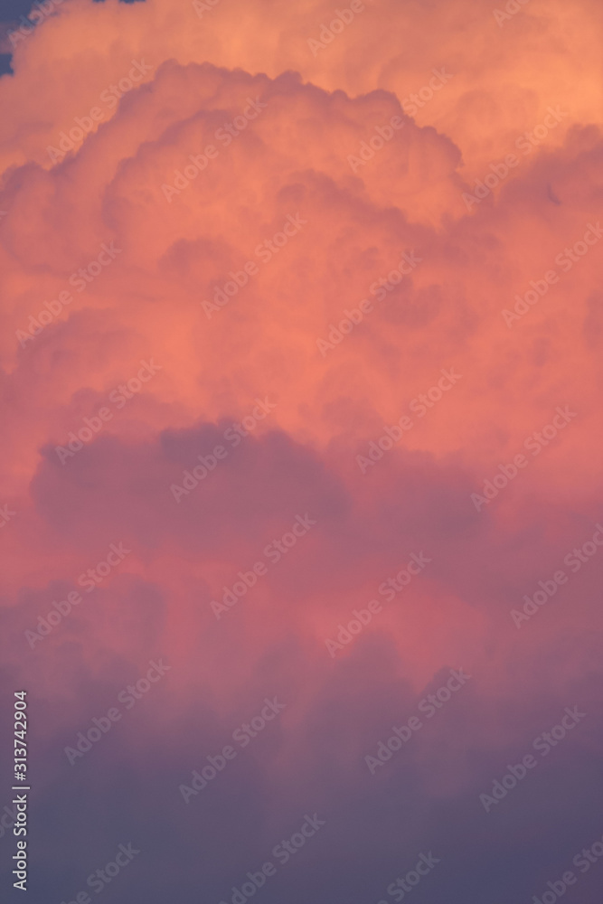 powerful sunset orange cumulonimbus cloud close up skyscape.yellow and red mushroom vertical cloud.powerful water vapor carried by upwards air currents.rain cloud