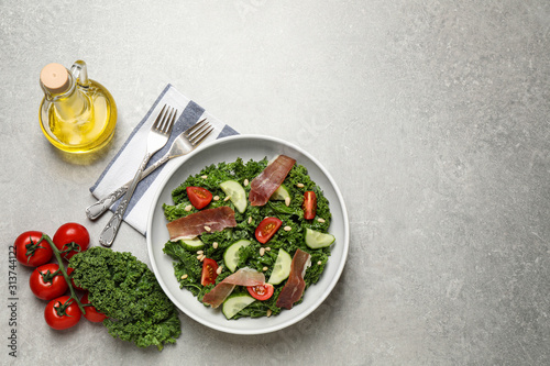 Delicious kale salad on light grey table, flat lay. Space for text