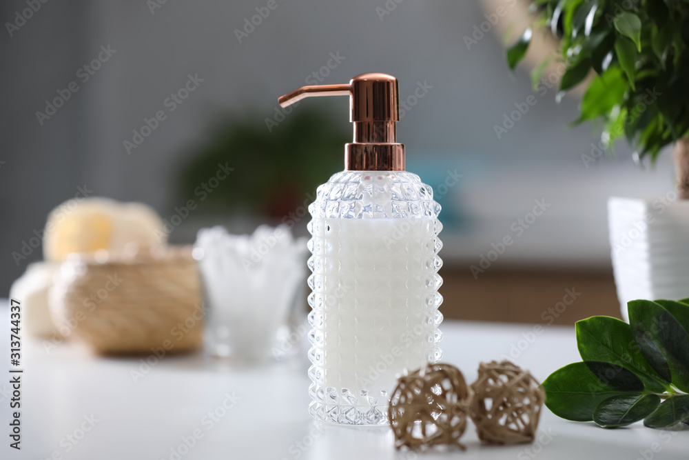 Stylish soap dispenser on white table indoors Stylish soap dispenser on white table indoors