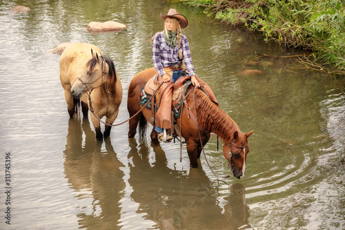Cowgirl on Horse in water