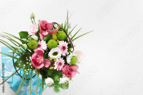 Flower bouquet with gift boxes on white background with copy space. Flat lay, top view. Valentine's Day or Mother's Day concept