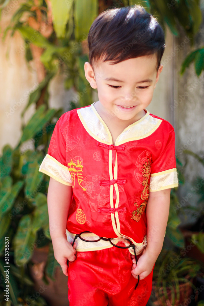 Asian boy smiling with traditional Chinese outfit. Dress up for Chinese new  year festival concept Stock Photo | Adobe Stock