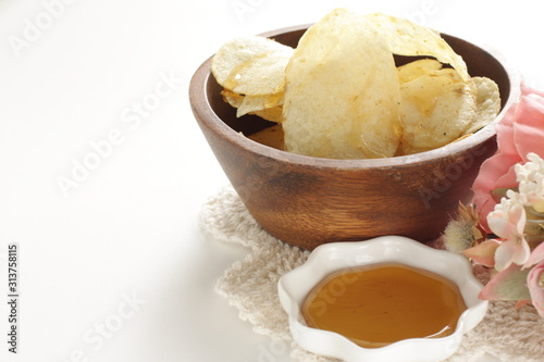 Potato chips and honey for snack food time